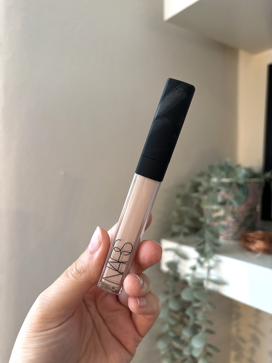 Mica Ricketts holding NARS Radiant Creamy Concealer