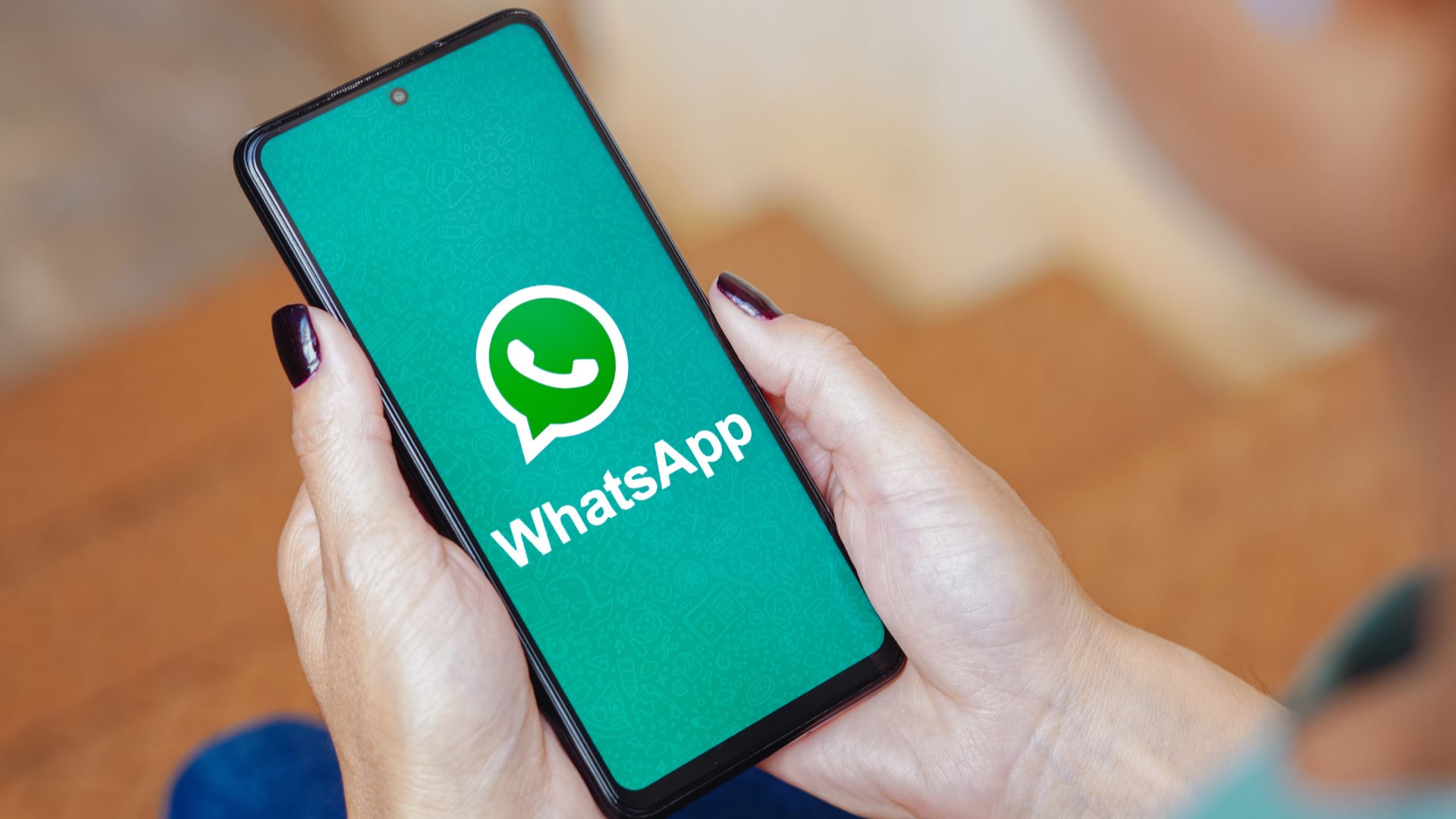 In this photo illustration, the WhatsApp logo is displayed on a smartphone screen.