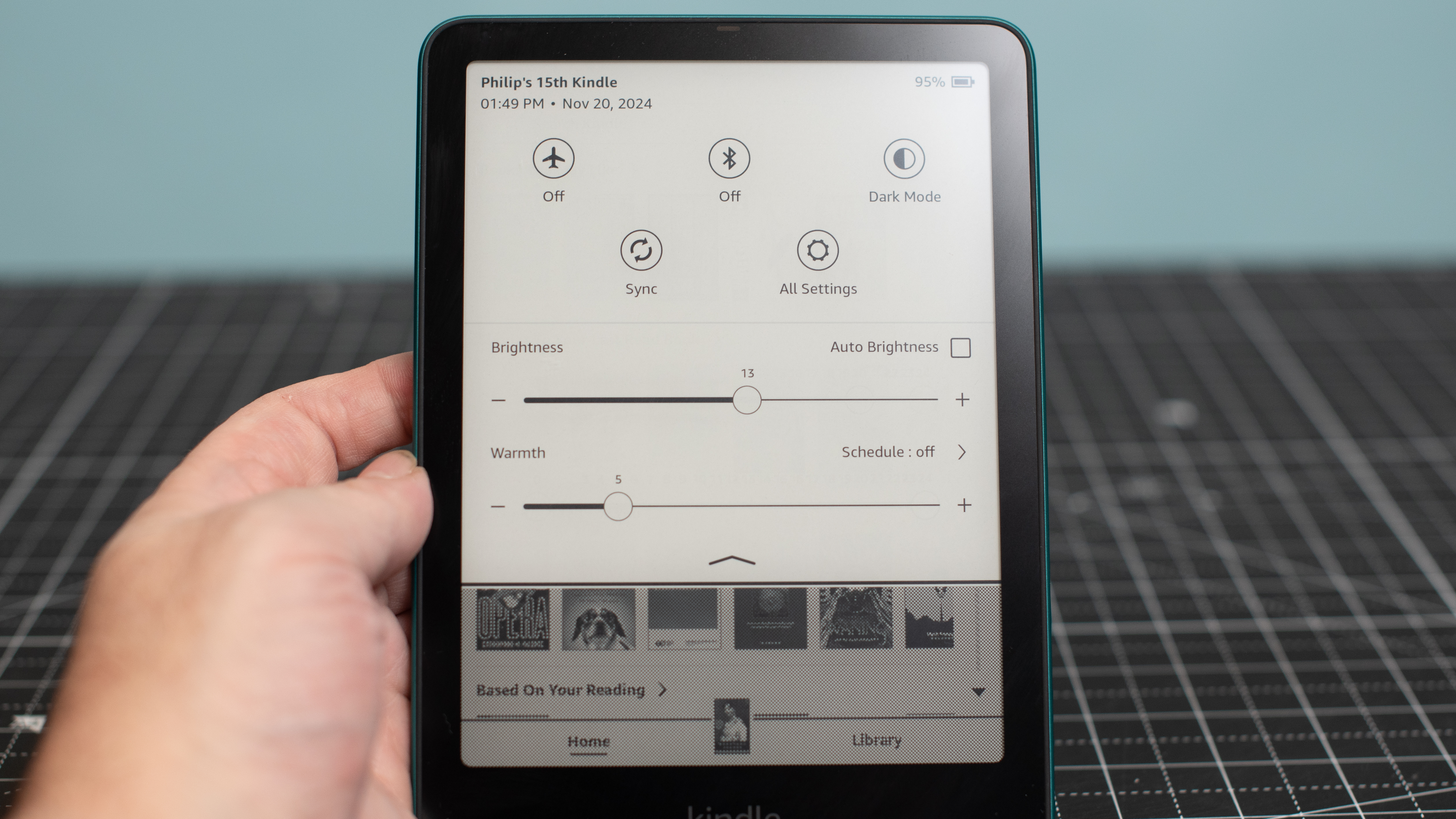 Kindle Paperwhite Signature Edition showing settings menu for screen brightness and warmth, Wi-Fi, Airplane mode, and more settings