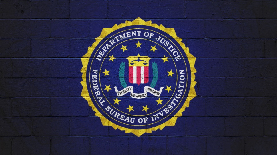 The FBI flag (Federal Bureau of Investigation) painted on a brick wall.