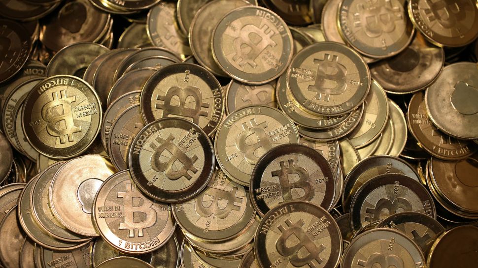 Pile of golden coins with BitCoin logo