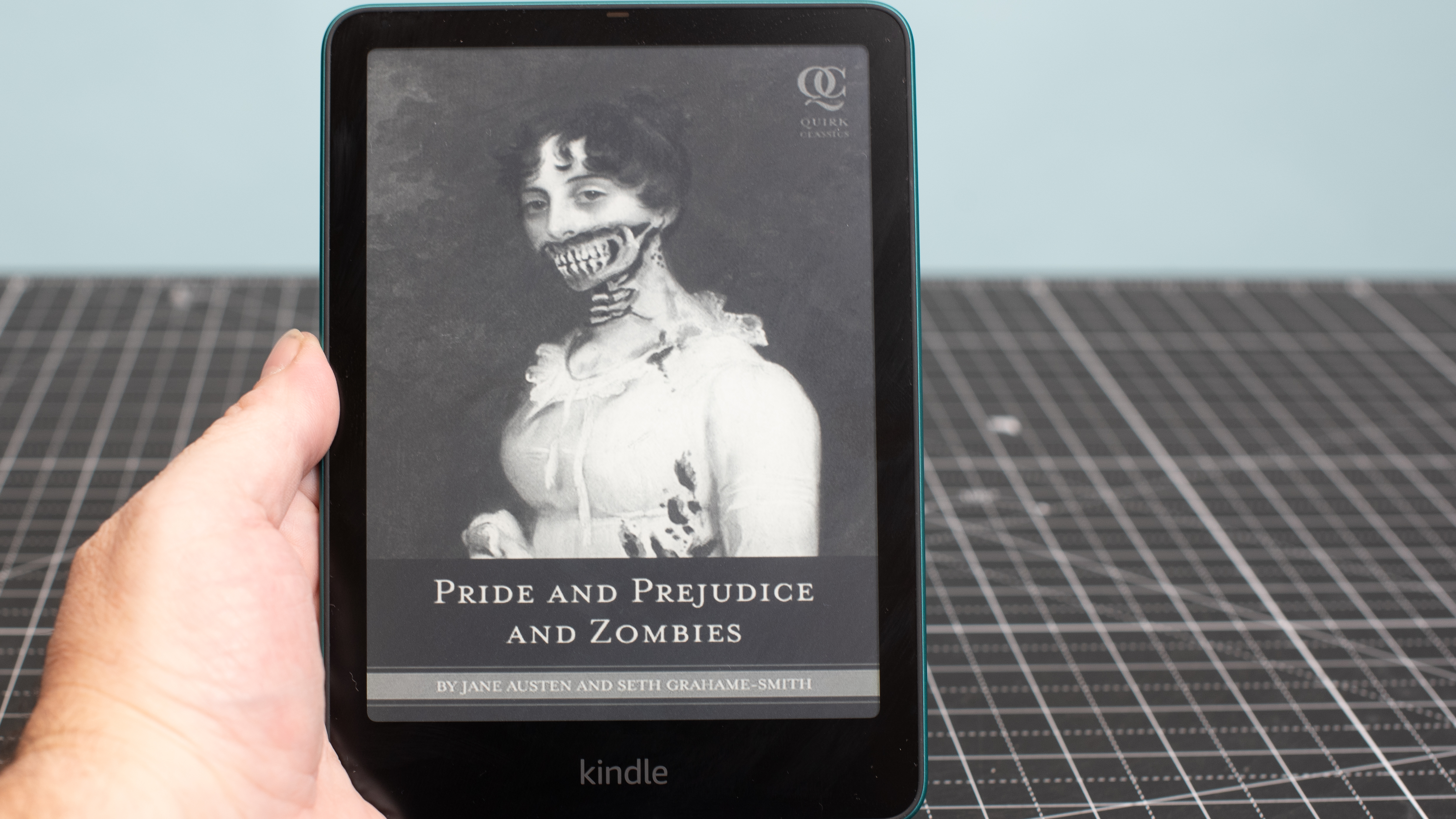 Kindle Paperwhite showing the cover of Pride and Prejudice and Zombies in black and white