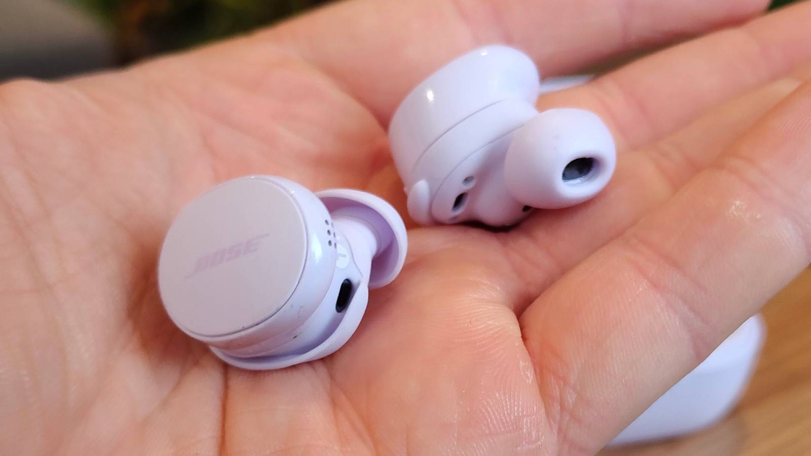 The Bose QuietComfort Earbuds 2024 pictured in the palm of the hand.