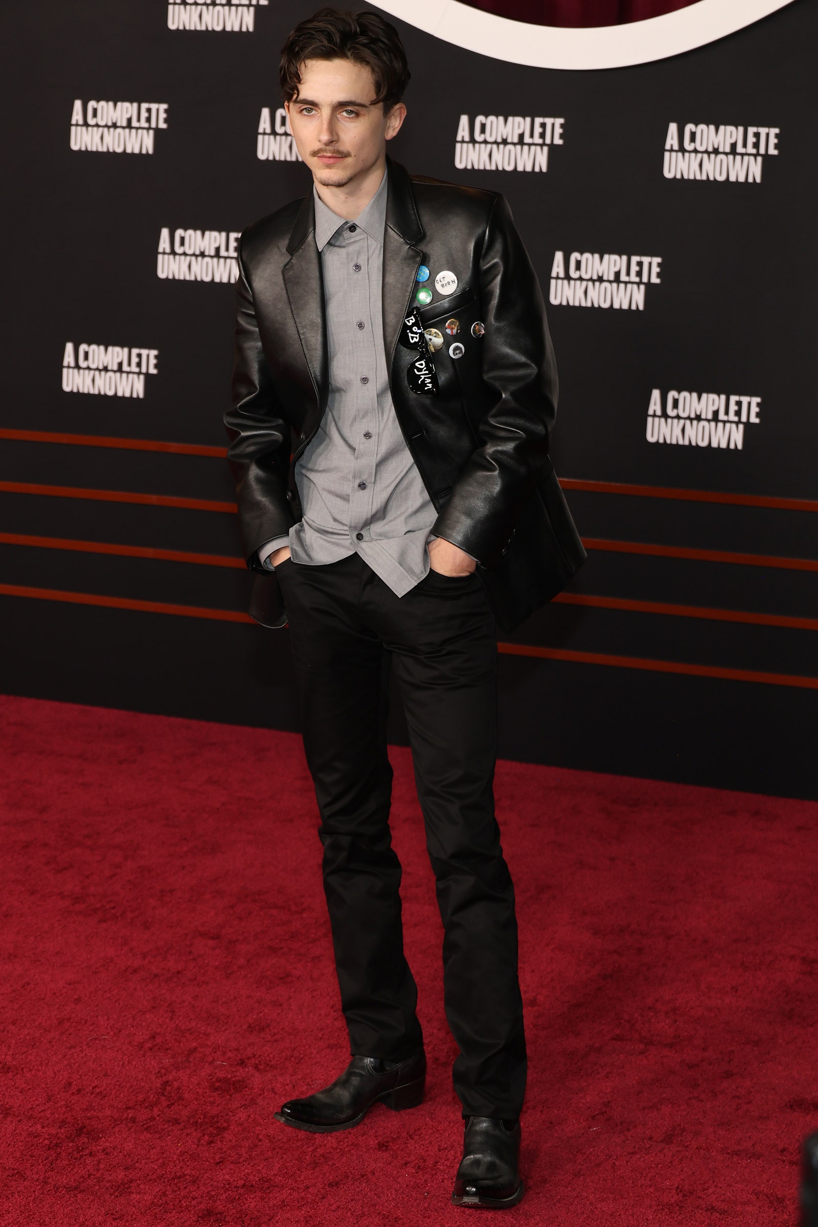 Image may contain Timothe Chalamet Clothing Coat Jacket Formal Wear Suit Fashion Adult Person Footwear and Shoe