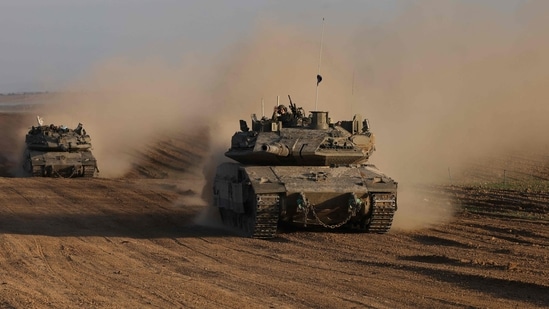 An Israeli soldier gestures from the top of army vehicle near the Israeli border fence with the Gaza Strip, on December 10, 2024, as the war between Israel and Hamas continues in Gaza. (Photo by Menahem KAHANA / AFP)(AFP)