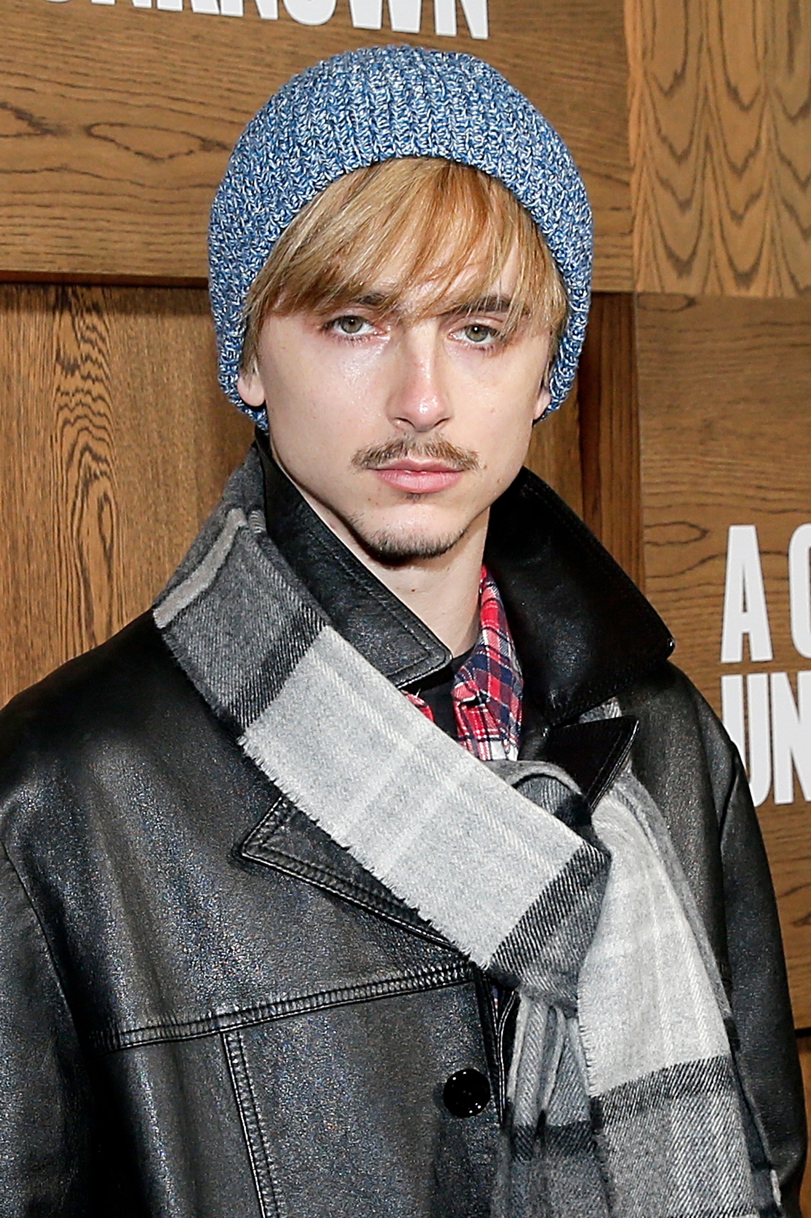 Image may contain Timothe Chalamet Clothing Coat Jacket Cap Hat Adult Person Blonde and Hair