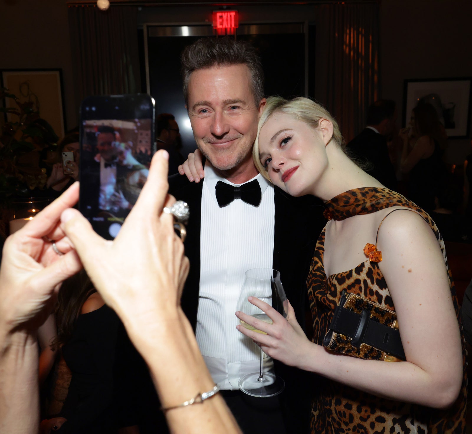 Image may contain Edward Norton Elle Fanning Accessories Formal Wear Tie Clothing Suit Face Head and Person