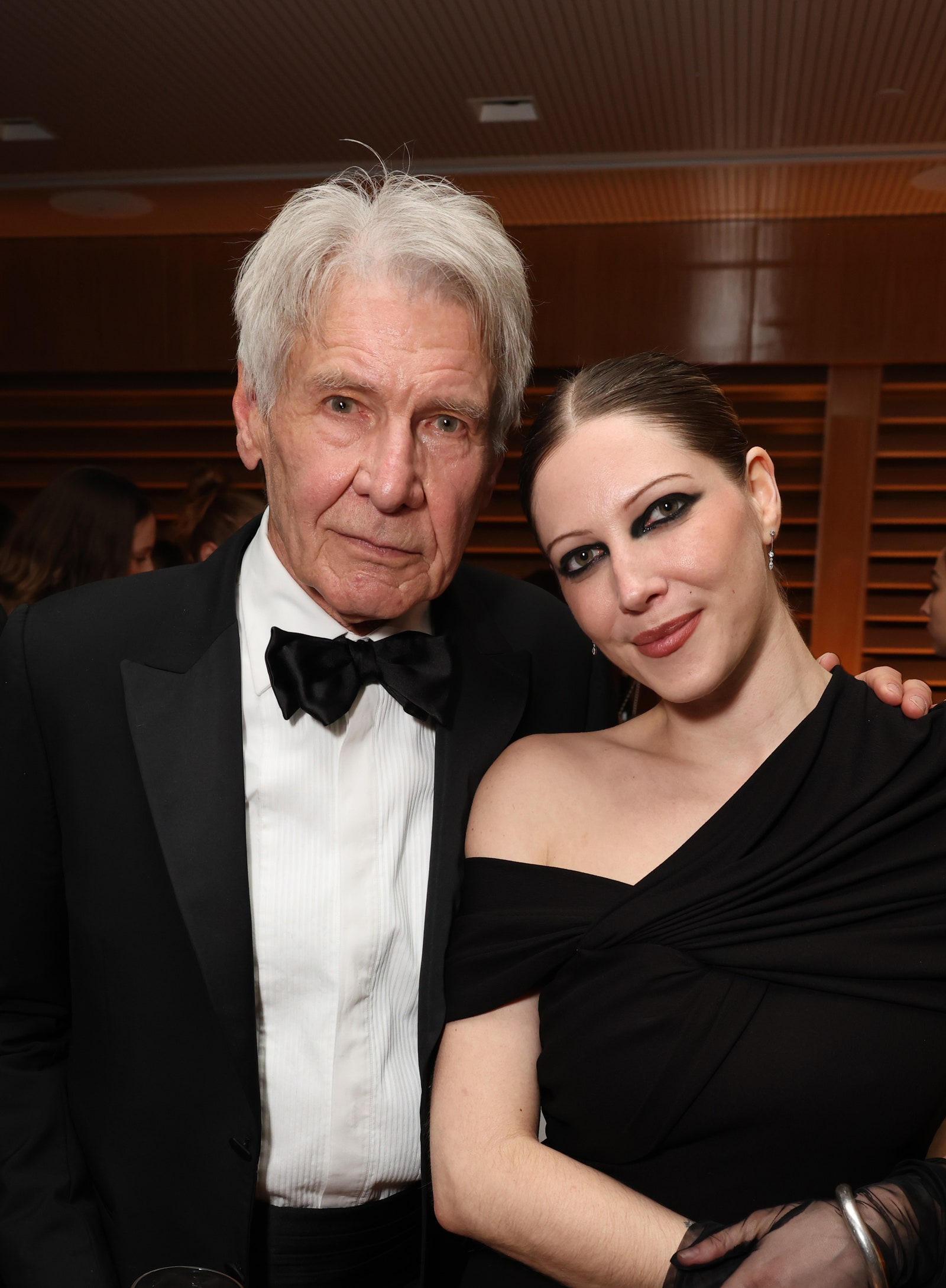 Image may contain Harrison Ford Lady Gabriella Kingston Clothing Formal Wear Suit Face Head Person and Photography