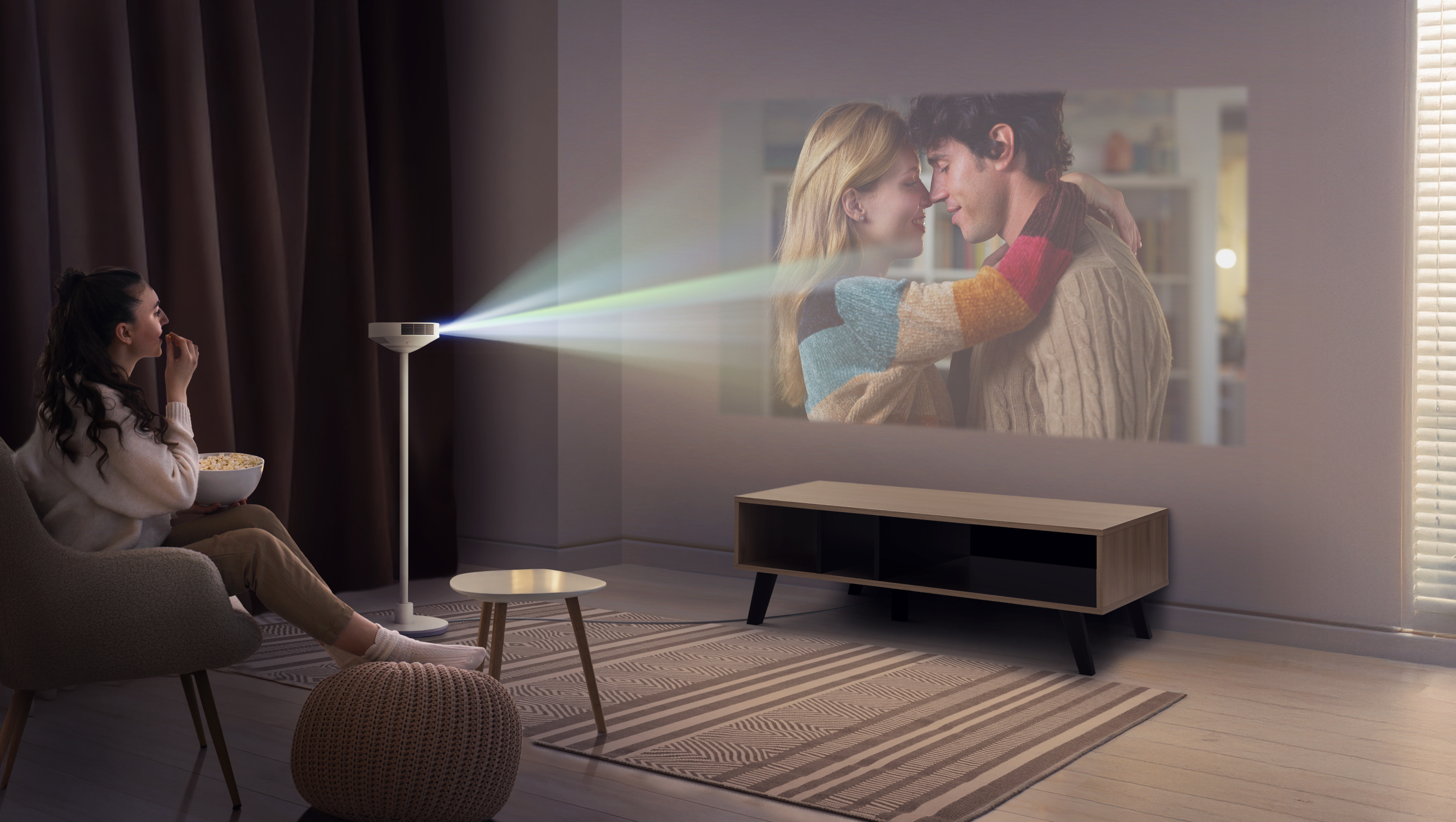 LG PF600U projector/lamp lifestyle image with woman in seat watching movie