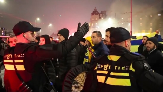 In this image taken from video, police escort Maccabi Tel Aviv supporters to the metro station leading them to the Ajax stadium, after pro-Palestinian supporters marched near the stadium, in Amsterdam(AP)