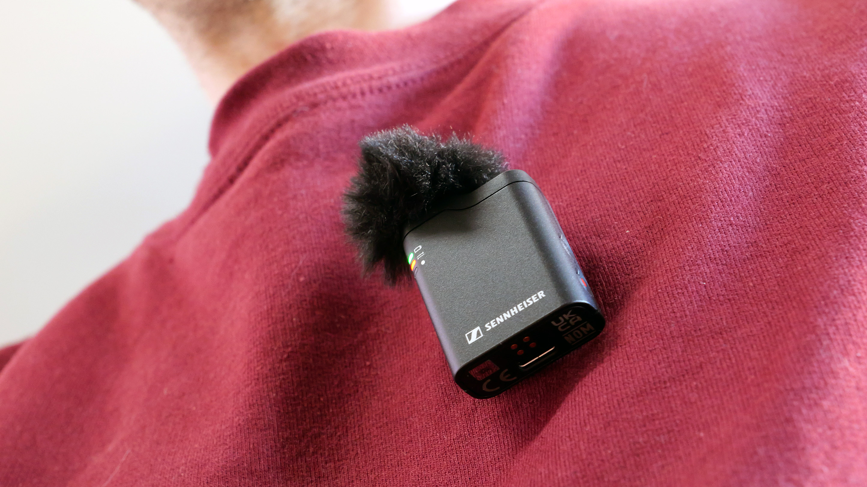 Sennheiser Profile Wireless microphone attached to maroon sweatshirt