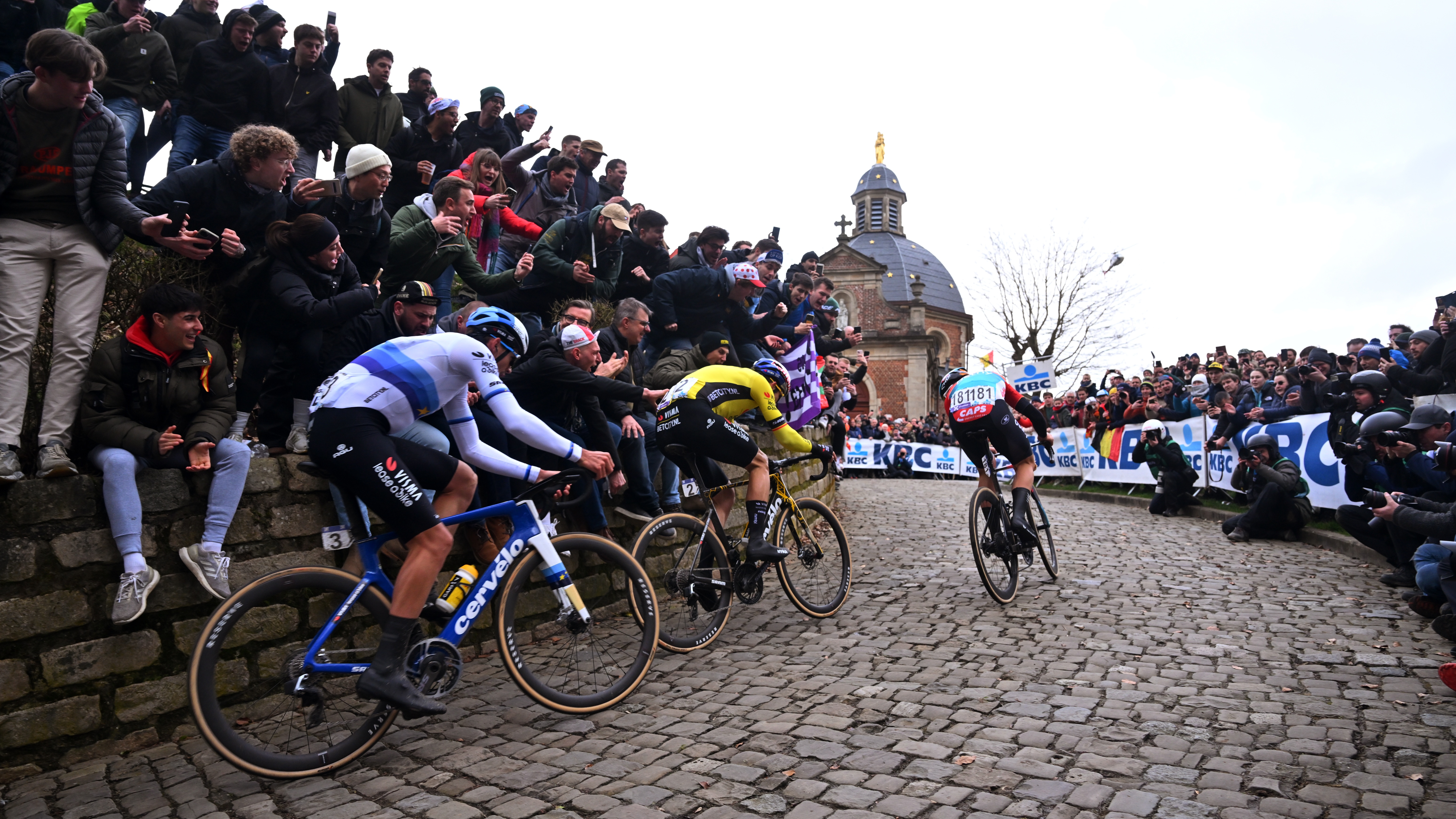 Christophe Laporte, Wout van Aert and Arnaud De Lie climb the Muur van Geraardsbergen in front of big crowds during the 2024 Omloop Het Nieuwsblad.