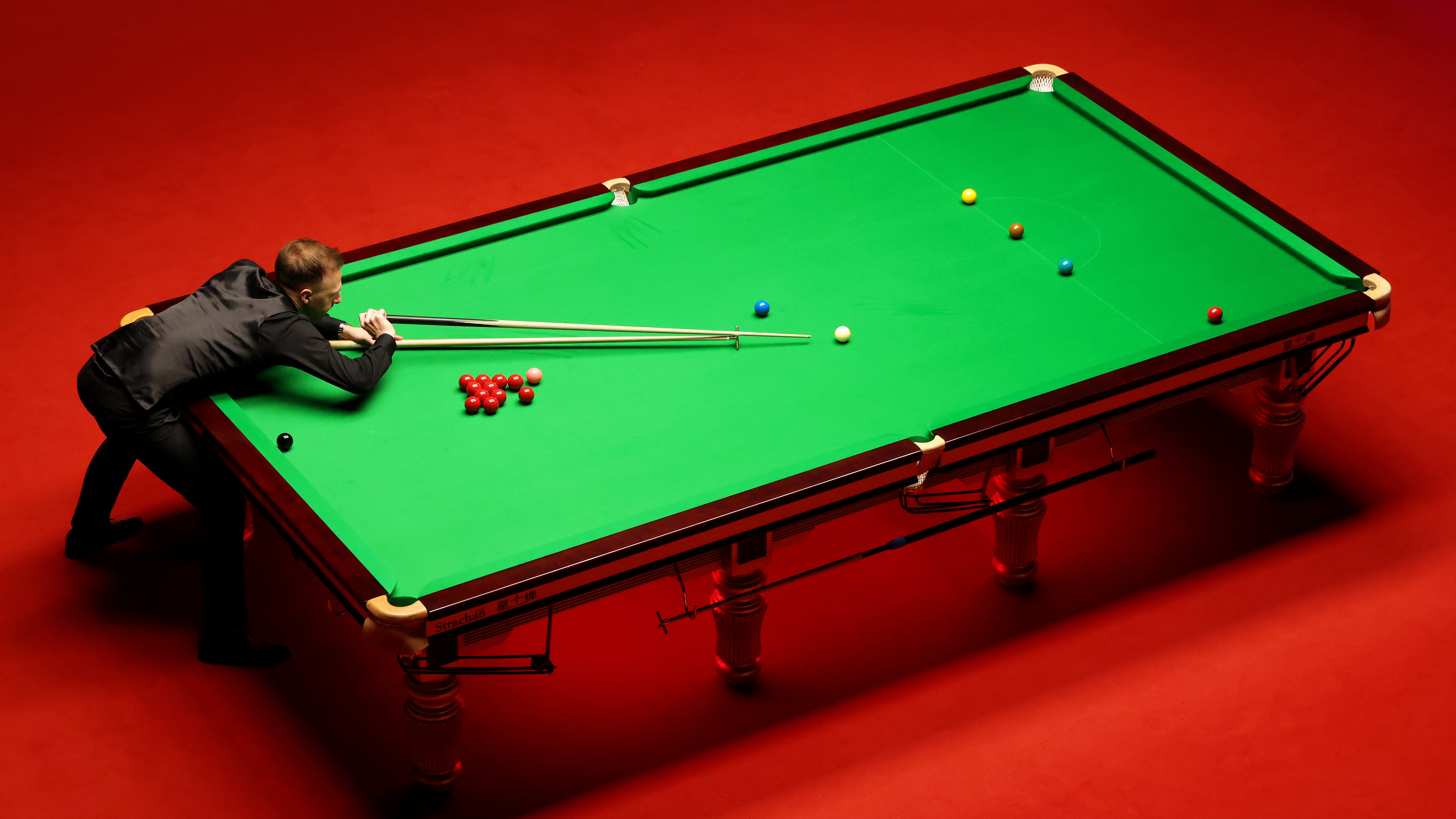 Judd Trump of England plays a shot during the World Snooker Championship Final match between Judd Trump of England and Ronnie O'Sullivan of England during Day Sixteen of the Betfred World Snooker Championship at Crucible Theatre in Sheffield, England. Photo by Lewis Storey/Getty Images