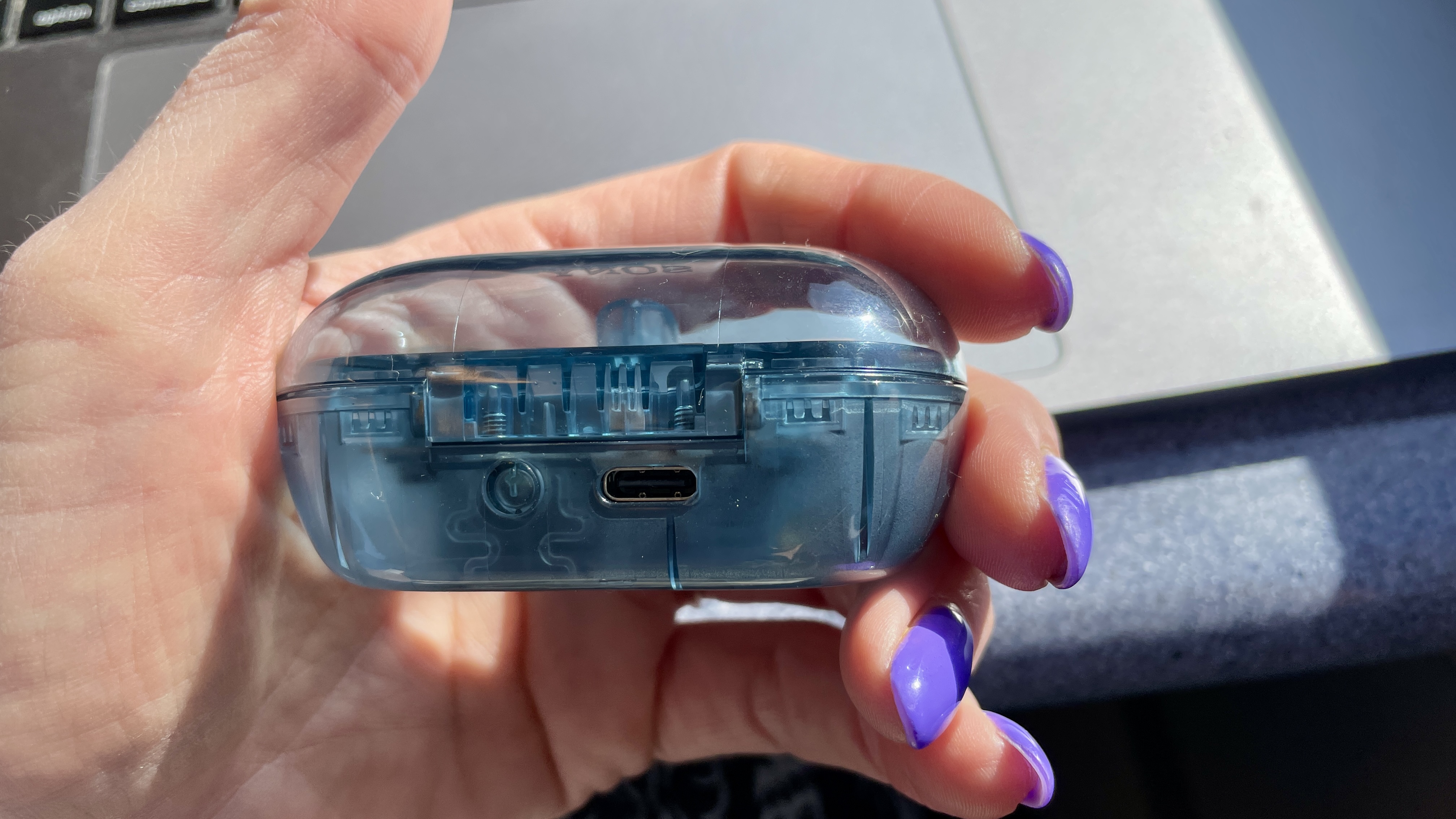 Sony WF-C710N held in a woman's hand